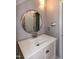 Bathroom with a round mirror, new vanity, and modern faucet at 101 Stefi Ct, Garner, NC 27529