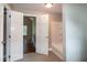 Hallway view into a bathroom with tile flooring and shower/tub combo at 101 Stefi Ct, Garner, NC 27529