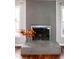 Close up view of the painted brick fireplace with glass doors and hearth at 101 Stefi Ct, Garner, NC 27529