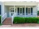 Close-up of the welcoming front porch with brick steps and manicured boxwood shrubs at 101 Stefi Ct, Garner, NC 27529