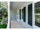 Inviting front porch featuring white columns and dark shuttered windows at 101 Stefi Ct, Garner, NC 27529