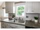Close-up of a gray kitchen sink with view to the yard at 101 Stefi Ct, Garner, NC 27529