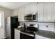 View of the stainless steel appliances and white cabinets in the kitchen at 101 Stefi Ct, Garner, NC 27529