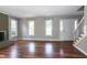 Spacious living room with hardwood floors, fireplace, and staircase at 101 Stefi Ct, Garner, NC 27529