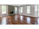 Open living room featuring a brick fireplace and gleaming hardwood floors at 101 Stefi Ct, Garner, NC 27529