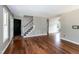 Open-concept living room with hardwood floors, staircase, and natural light at 101 Stefi Ct, Garner, NC 27529