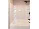 A bright white tiled shower and bathtub combo features a modern shower head at 101 Stefi Ct, Garner, NC 27529