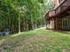 Large backyard with mature trees and a second story deck at 10101 Daviton Ct, Raleigh, NC 27615