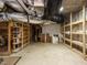 Unfinished basement with exposed ductwork and wooden shelving at 10101 Daviton Ct, Raleigh, NC 27615