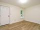 This bedroom features a sleek door and a window, complemented by modern flooring for a comfortable living space at 10101 Daviton Ct, Raleigh, NC 27615