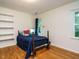 Cozy bedroom with hardwood floors, natural light, and built-in shelving at 10101 Daviton Ct, Raleigh, NC 27615