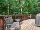 Wooden deck with metal chairs surrounded by mature trees at 10101 Daviton Ct, Raleigh, NC 27615