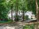Charming two-story home nestled among mature trees with a long driveway at 10101 Daviton Ct, Raleigh, NC 27615