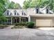 Charming traditional home featuring a two-car garage and dormer windows, nestled among lush trees at 10101 Daviton Ct, Raleigh, NC 27615