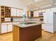 Bright kitchen featuring white cabinets, center island, and modern appliances at 10101 Daviton Ct, Raleigh, NC 27615