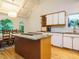 Kitchen with center island, white cabinets, and window views at 10101 Daviton Ct, Raleigh, NC 27615