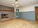 Stylish living room features a fireplace, a blue accent wall, and tile floors, creating a cozy yet modern ambiance at 10101 Daviton Ct, Raleigh, NC 27615