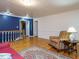 Open living room with wood floors, a chair, and stairs at 10101 Daviton Ct, Raleigh, NC 27615