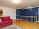 Spacious living room featuring wood floors and a blue accent wall at 10101 Daviton Ct, Raleigh, NC 27615