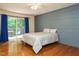 Bedroom with blue accent wall, ceiling fan, and sliding glass door to deck at 10101 Daviton Ct, Raleigh, NC 27615