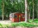 Red shed with painted flower detail surrounded by trees at 10101 Daviton Ct, Raleigh, NC 27615