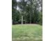 Expansive backyard featuring lush green grass and mature trees creating a private, natural setting at 108 Sweetbay Park, Youngsville, NC 27596