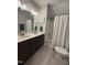 Well-appointed bathroom with double sinks, modern fixtures, and a bathtub, providing comfort and style at 108 Sweetbay Park, Youngsville, NC 27596