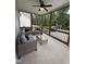 Inviting covered patio with comfortable seating, ceiling fan, and a view of the serene backyard at 108 Sweetbay Park, Youngsville, NC 27596