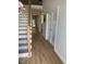 Welcoming entryway with hardwood floors, stairs with decorative metalwork, and a view into the home at 108 Sweetbay Park, Youngsville, NC 27596