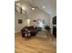 Cozy living room with high ceilings, a fireplace, and a comfortable leather sectional at 108 Sweetbay Park, Youngsville, NC 27596