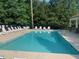 Sparkling community pool surrounded by lounge chairs, perfect for enjoying sunny days at 108 Sweetbay Park, Youngsville, NC 27596