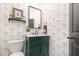 Charming half-bathroom featuring floral wallpaper, a stylish vanity, and a modern toilet at 10847 Bedfordtown Dr, Raleigh, NC 27614