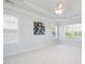 Airy bedroom features soft carpet, neutral paint, large windows, and a tray ceiling with ceiling fan at 10847 Bedfordtown Dr, Raleigh, NC 27614