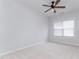This bedroom has a neutral paint color, carpet, and a window at 10847 Bedfordtown Dr, Raleigh, NC 27614
