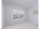 Bright bedroom features a neutral color scheme and large window at 10847 Bedfordtown Dr, Raleigh, NC 27614