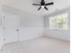 Well-lit bedroom with fan, window, and wainscoting at 10847 Bedfordtown Dr, Raleigh, NC 27614