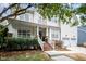 Charming two-story home featuring a welcoming front porch with a swing and a well-manicured lawn at 10847 Bedfordtown Dr, Raleigh, NC 27614