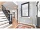 Elegant foyer featuring hardwood floors, a staircase with black railings, and a decorative mirror at 10847 Bedfordtown Dr, Raleigh, NC 27614