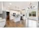 Bright kitchen boasts white cabinets, stainless steel appliances, a center island, and hardwood floors at 10847 Bedfordtown Dr, Raleigh, NC 27614