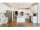 Modern kitchen featuring white cabinets, stainless steel appliances, and an island with granite countertops at 10847 Bedfordtown Dr, Raleigh, NC 27614