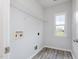Bright laundry room features vinyl floors, hookups for the washer and dryer, and a wire shelf at 10847 Bedfordtown Dr, Raleigh, NC 27614