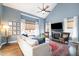 Inviting living room features a fireplace, a large window, comfortable seating, and hardwood floors at 10847 Bedfordtown Dr, Raleigh, NC 27614