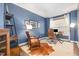 Stylish home office featuring a leather chair, wooden desk, and ample natural light at 10847 Bedfordtown Dr, Raleigh, NC 27614