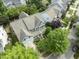 A residential home is nestled among lush trees in a neighborhood, aerial view at 10859 Bedfordtown Dr, Raleigh, NC 27614