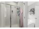 Bathroom featuring a glass-enclosed shower, soaking tub, and linen shelves at 10859 Bedfordtown Dr, Raleigh, NC 27614