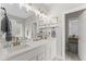 Bright bathroom with double vanity, modern lighting, and tile floor at 10859 Bedfordtown Dr, Raleigh, NC 27614