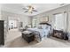 Comfortable bedroom with blue and white accents, ceiling fan, and view to sitting room at 10859 Bedfordtown Dr, Raleigh, NC 27614