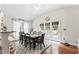 Bright dining area with large windows, access to outdoor space, and comfortable seating for gatherings at 10859 Bedfordtown Dr, Raleigh, NC 27614