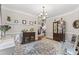 Elegant dining room with hardwood floors, wainscoting, and decorative accents creates an inviting atmosphere at 10859 Bedfordtown Dr, Raleigh, NC 27614