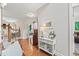 Inviting entryway with hardwood floors, white console table, and decorative accents provides a warm welcome at 10859 Bedfordtown Dr, Raleigh, NC 27614